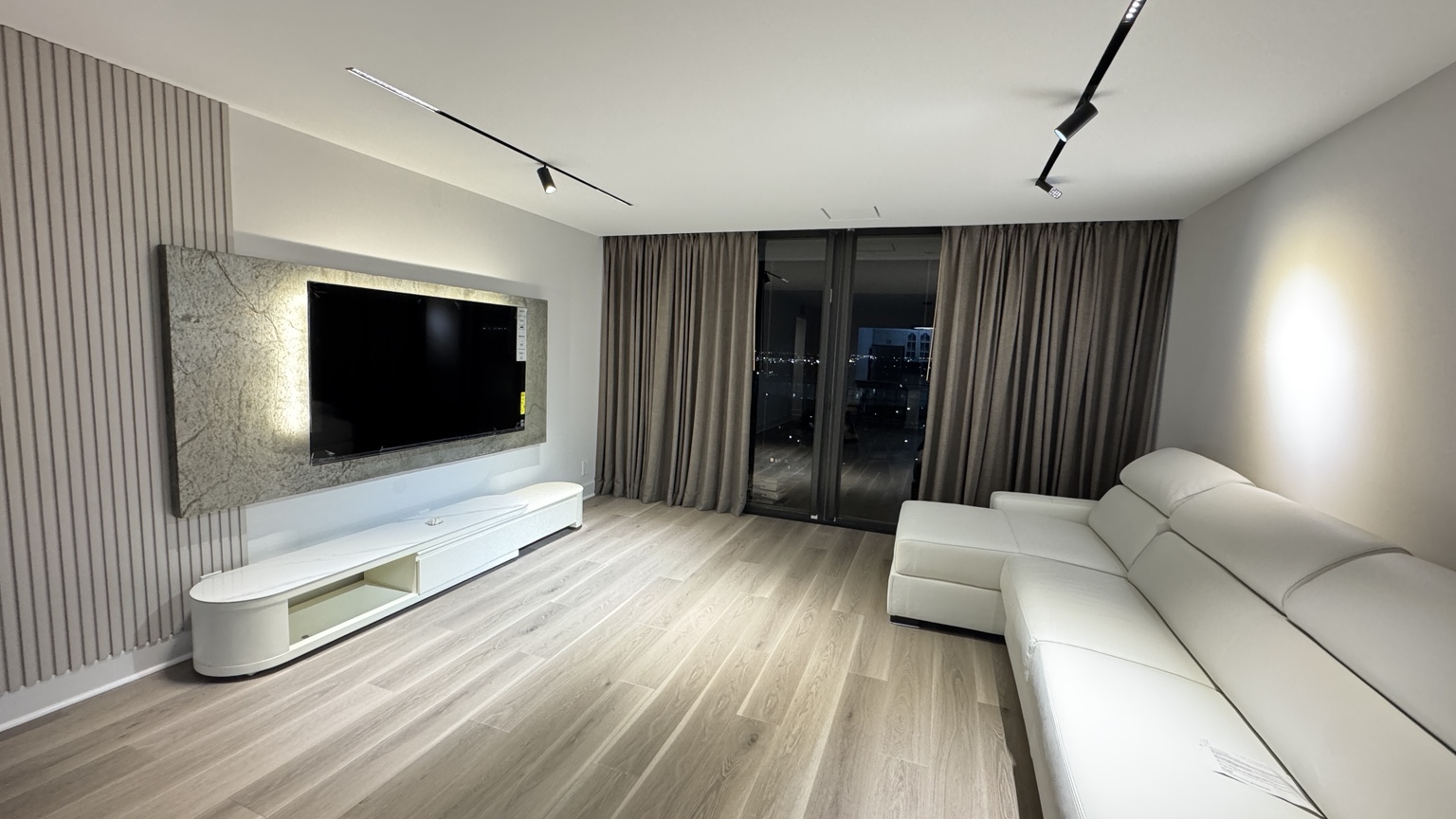 Modern condo interior with fresh paint, feature wall and updated lighting