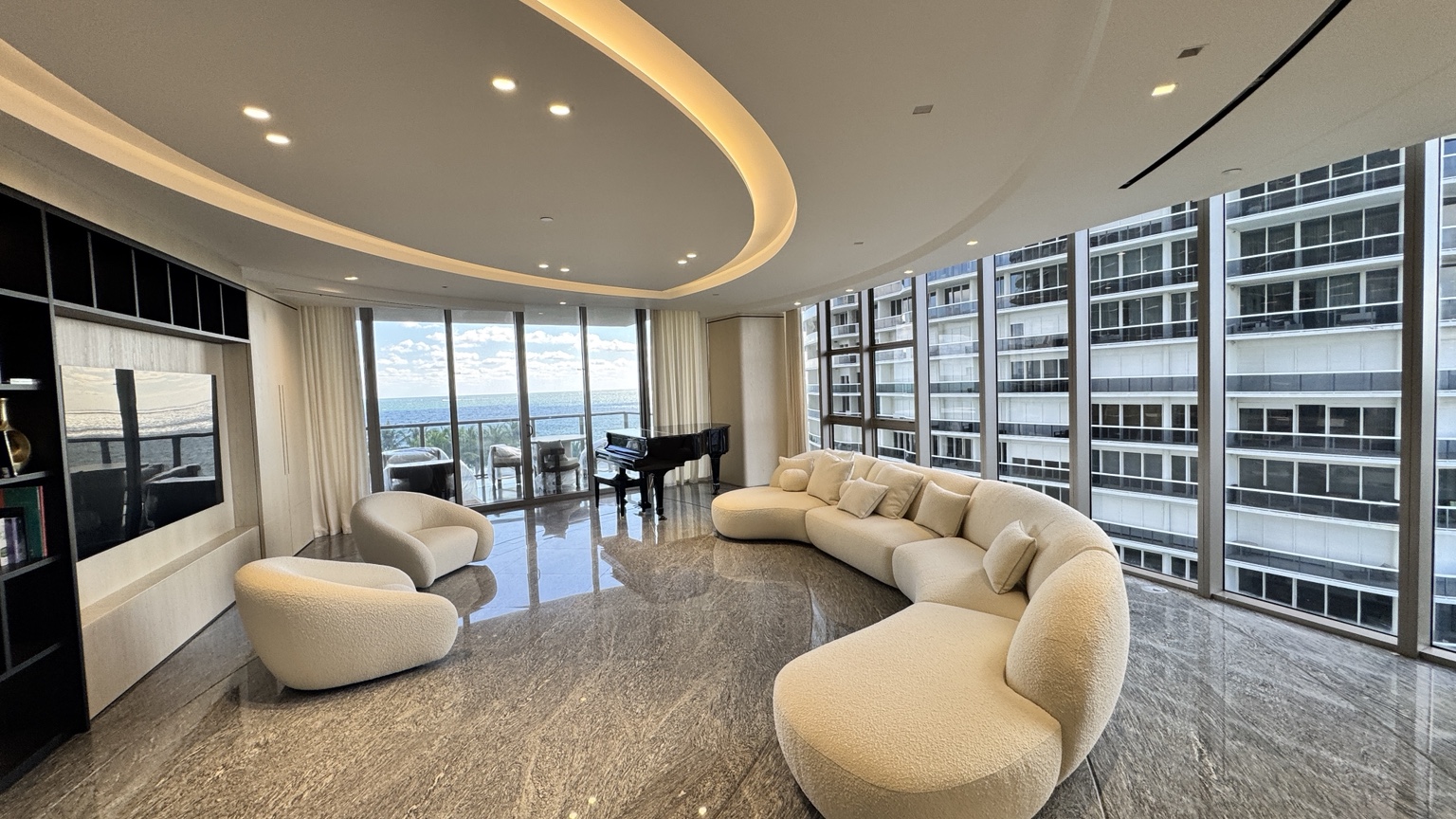 Bright, freshly painted luxury oceanfront living room with smooth wall finishes and ocean views